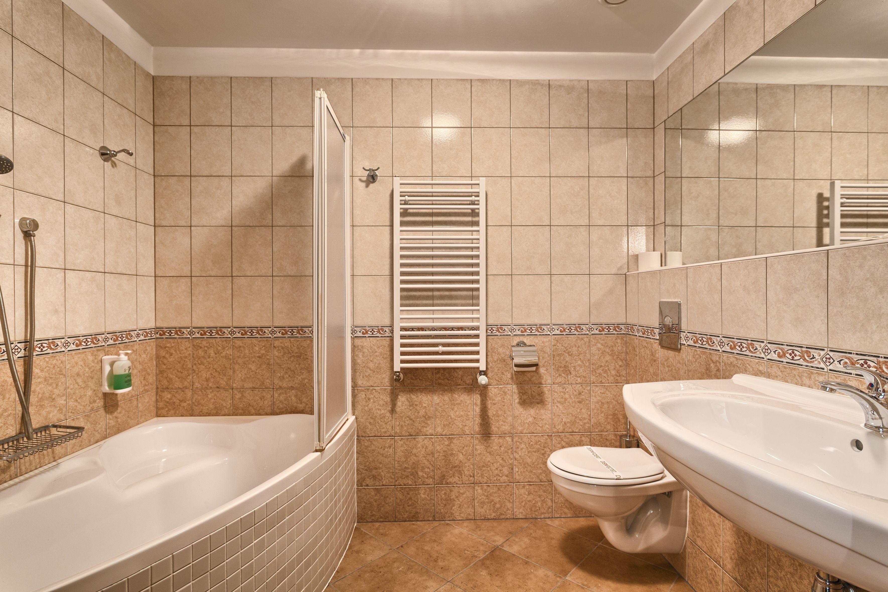 A bathroom with a bathtub, toilet, and sink.