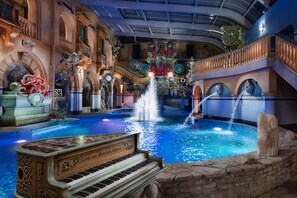 A grand lobby with a fountain, a grand piano, and ornate architectural details. - Wellness Hotel Babylon (Liberec)