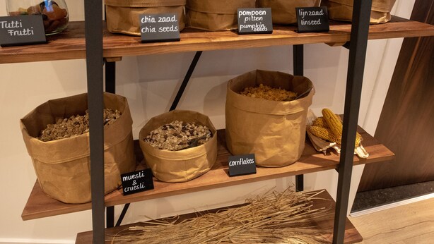 A display of various grains and seeds on shelves. - Flonk Hotel Groningen Centre, BW Signature Collection (Groningen)