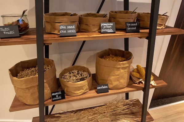 A display of various grains and seeds on shelves.