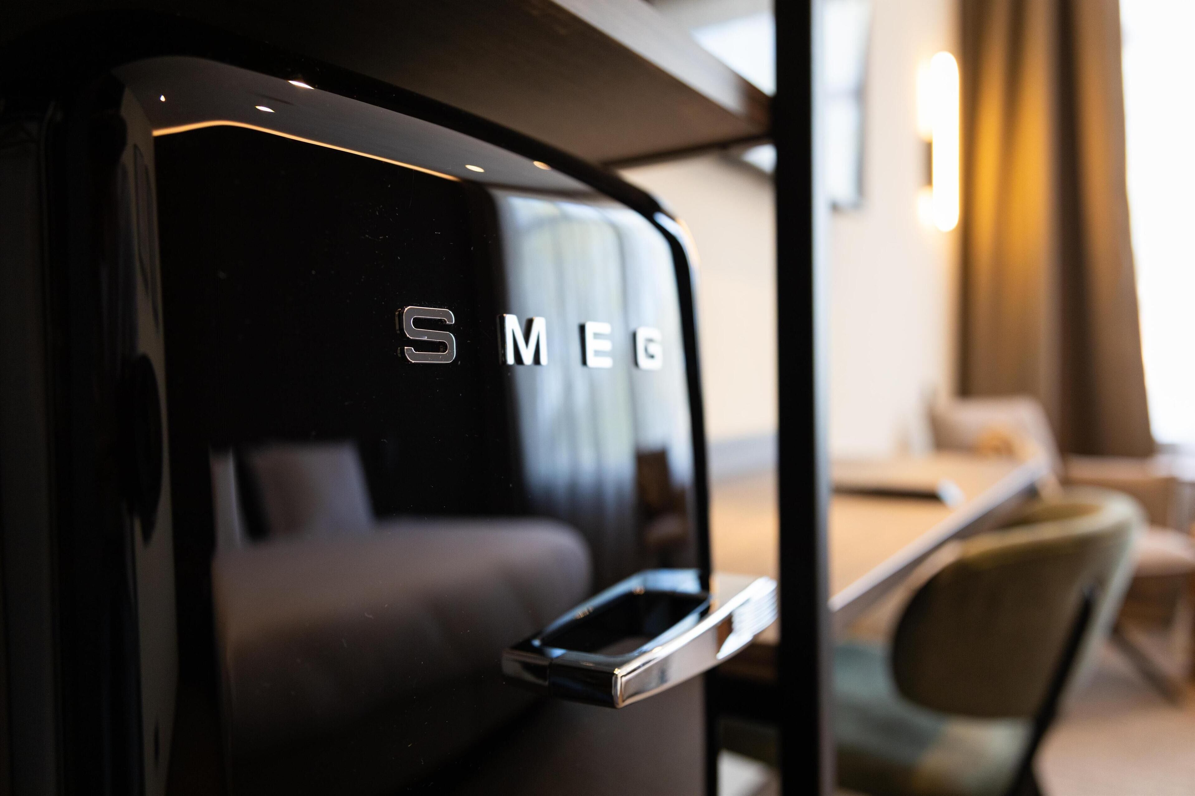 A modern interior with a black wall and a metallic handle.