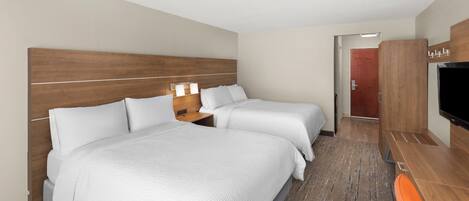 A hotel room with two beds, a desk, a TV, and a door with a number.