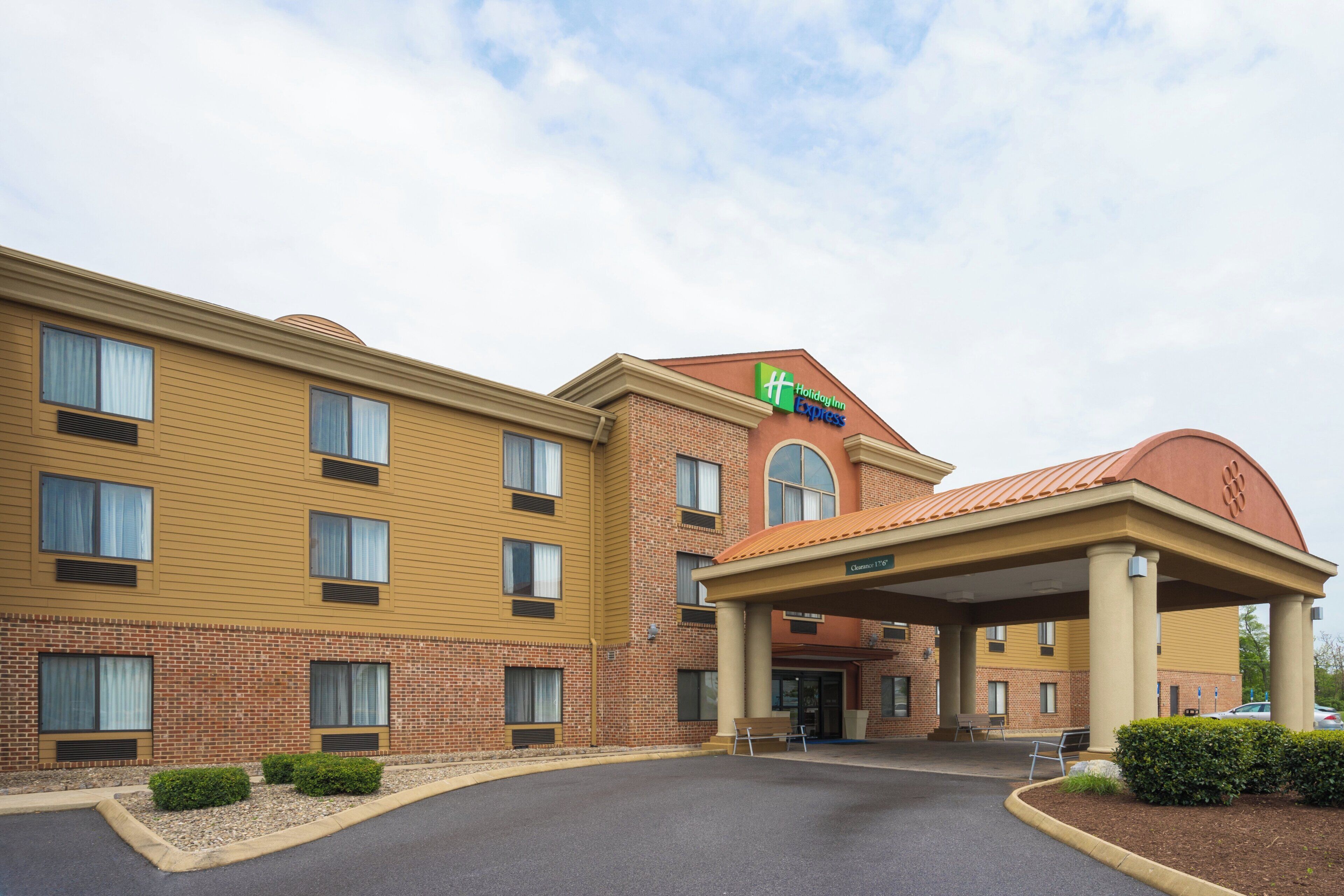 A Holiday Inn Express building with a brick facade, multiple windows, and a covered entrance.