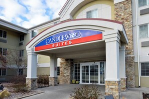 The exterior of Candlewood Suites hotel with a stone facade and a blue and red sign. - Candlewood Suites Boise-Meridian by IHG (Meridian)