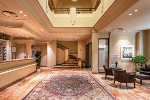 A hotel lobby with a reception desk, seating area, staircase, and a large patterned carpet. - Best Western Hotel Stella D'Italia (Marsala)