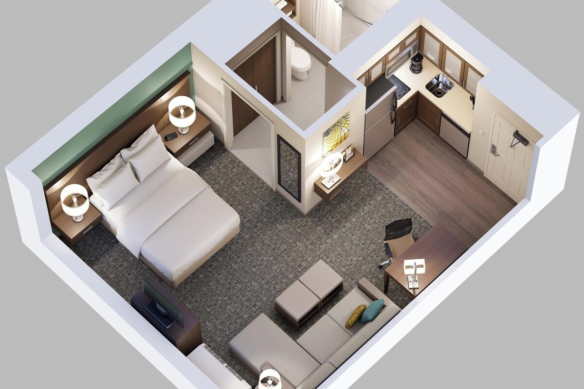 Plano de planta en 3D de una habitación de hotel con cama, zona de estar, kitchenette, baño y un pequeño balcón.