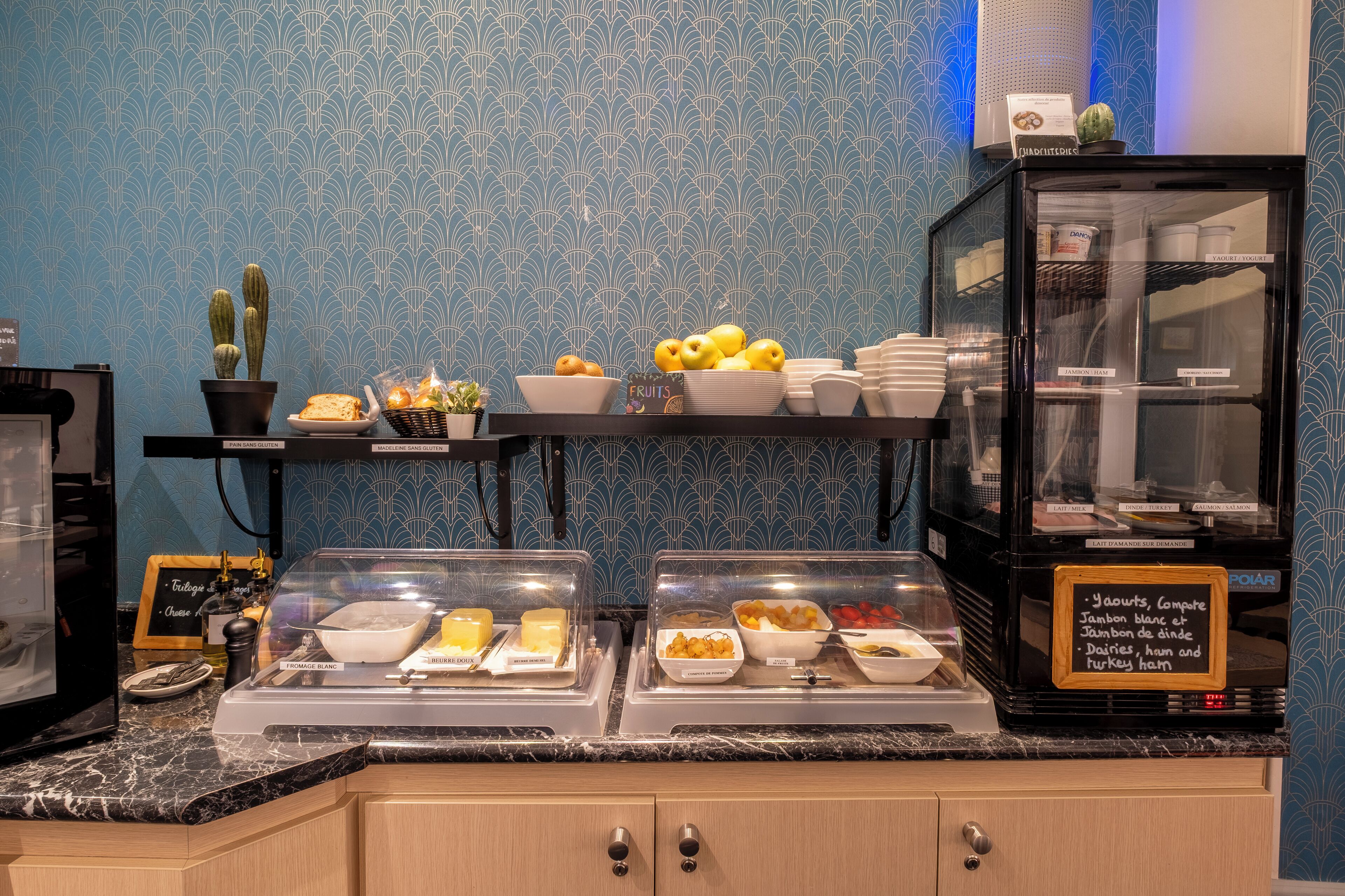A buffet area with various food items and a chalkboard menu.