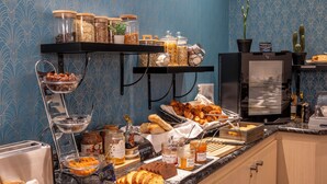 A breakfast buffet with various food items, a toaster, and a refrigerator.