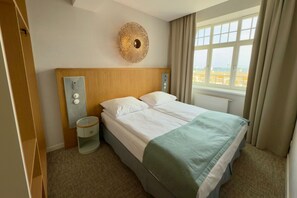 Deluxe Studio Suite, Sea View | In-room safe, desk, laptop workspace, blackout drapes