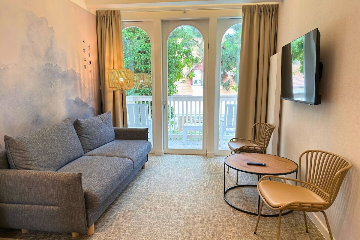 Deluxe Suite, Balcony, Partial Sea View | In-room safe, desk, laptop workspace, blackout drapes