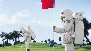 Astronauts tee off on our lush golf course, where a challenging flag awaits.