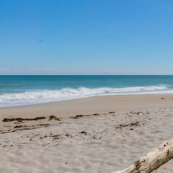 Enjoy a serene beach experience with calm seas and sandy shores.
