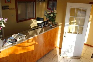 Welcome to our reception area, where friendly staff are available to assist with your stay. A comfortable seating area and amenities are nearby.