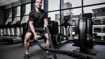 A gym with exercise equipment, including treadmills and weight machines.
