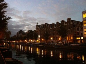 A canal with buildings reflecting on the water.