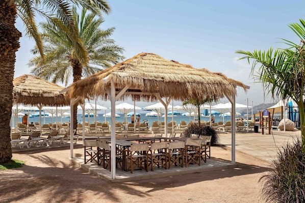 On the beach, sun-loungers, beach umbrellas, beach towels