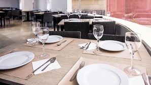 A restaurant with tables set for dining, featuring white plates, cutlery, and water glasses. - RVHotels Mar de Tossa (Tossa de Mar)