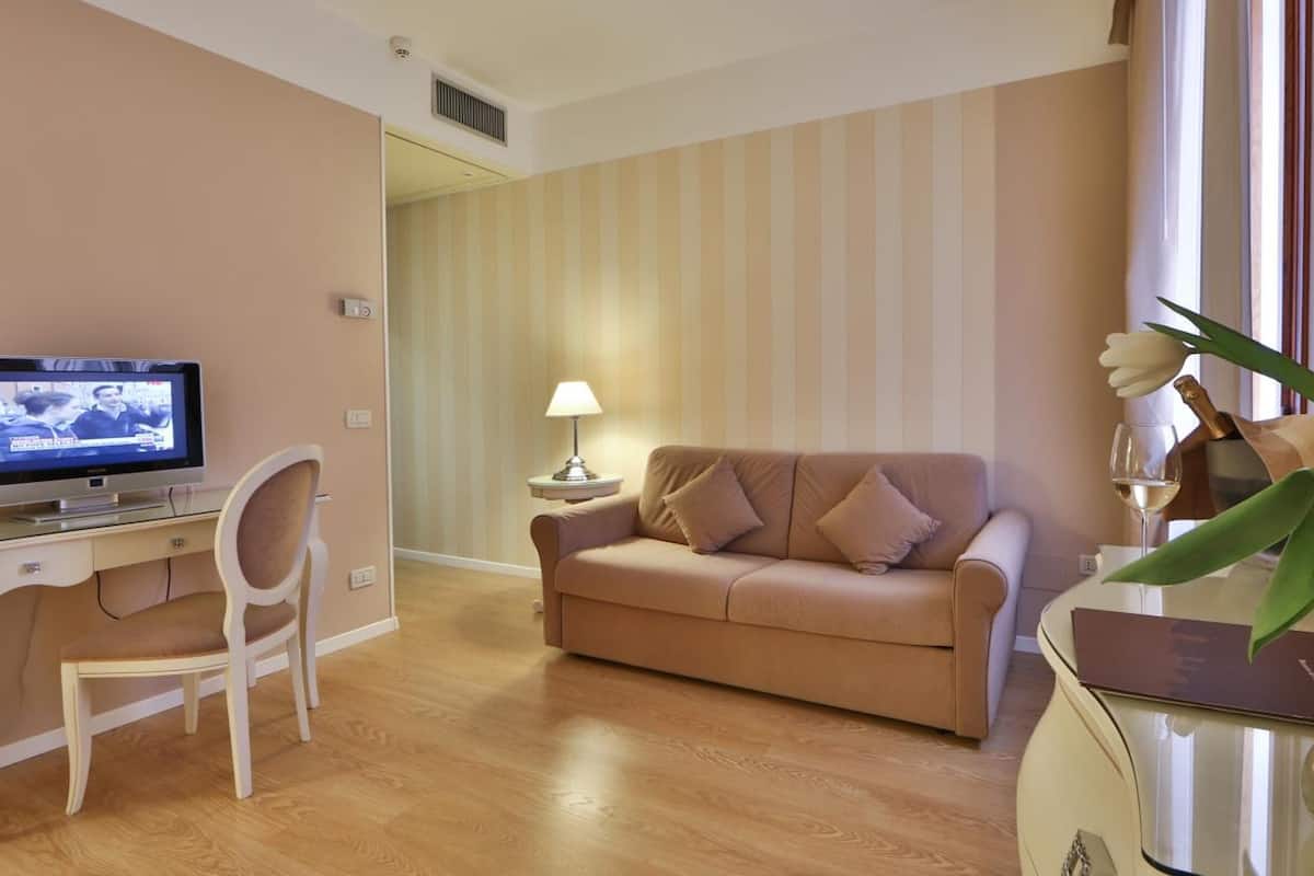 junior suite (deluxe) | living room | 32-inch tv with satellite channels