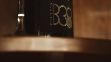 A wine bottle with a label and a wine glass.