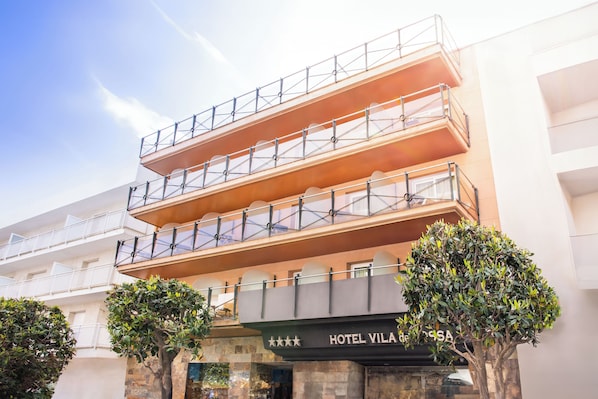 A multi-story hotel with a modern design, featuring balconies on each floor and a prominent sign indicating the name "HOTEL VILA de SA".