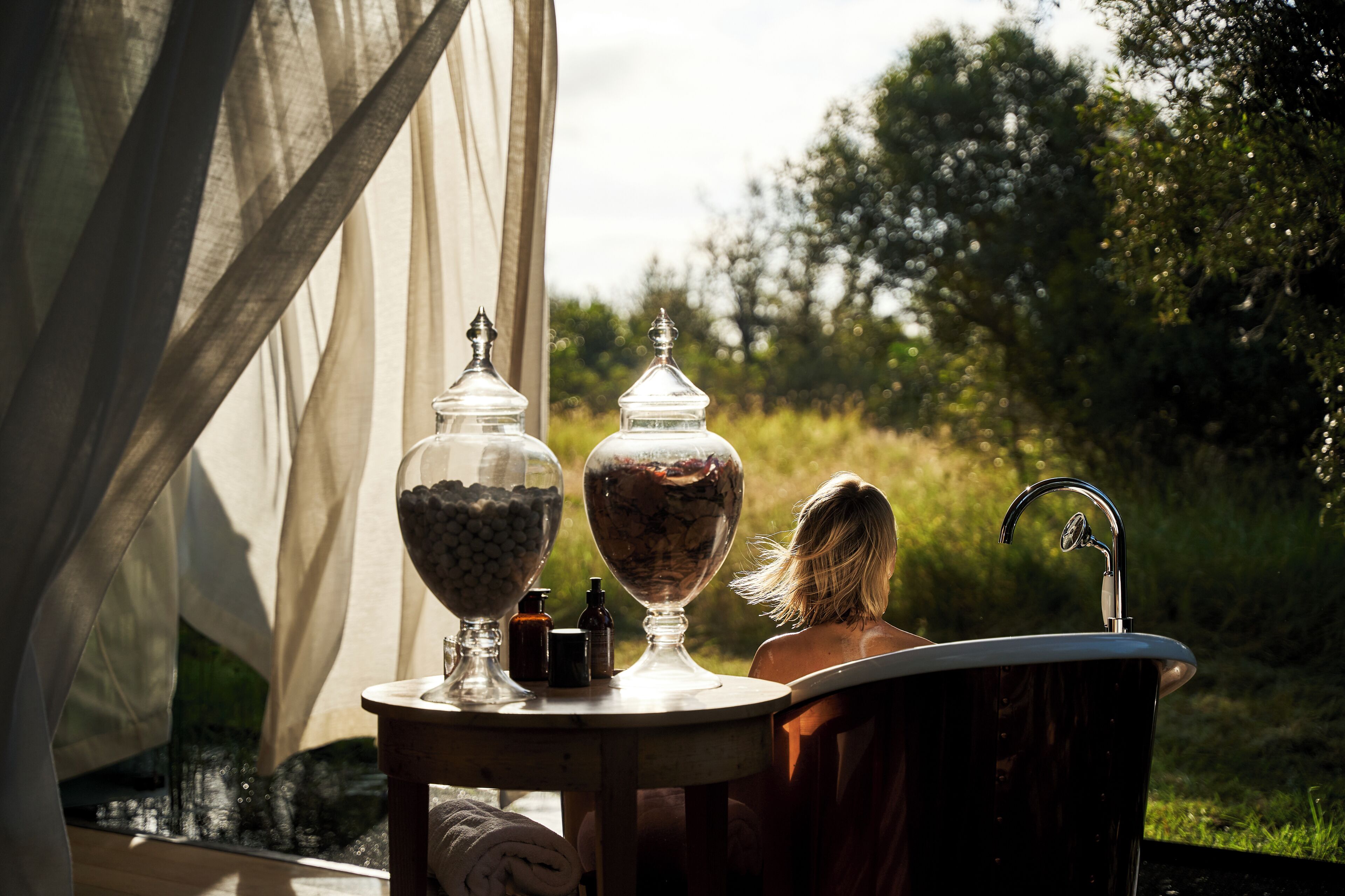 A tent with a table and a bathtub.