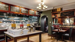 A restaurant with a bar area, a coffee station, and a wine display.