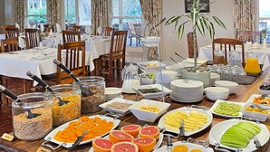A buffet with various food items including fruits, cereals, and beverages. - Zuurberg Mountain Village (Addo)