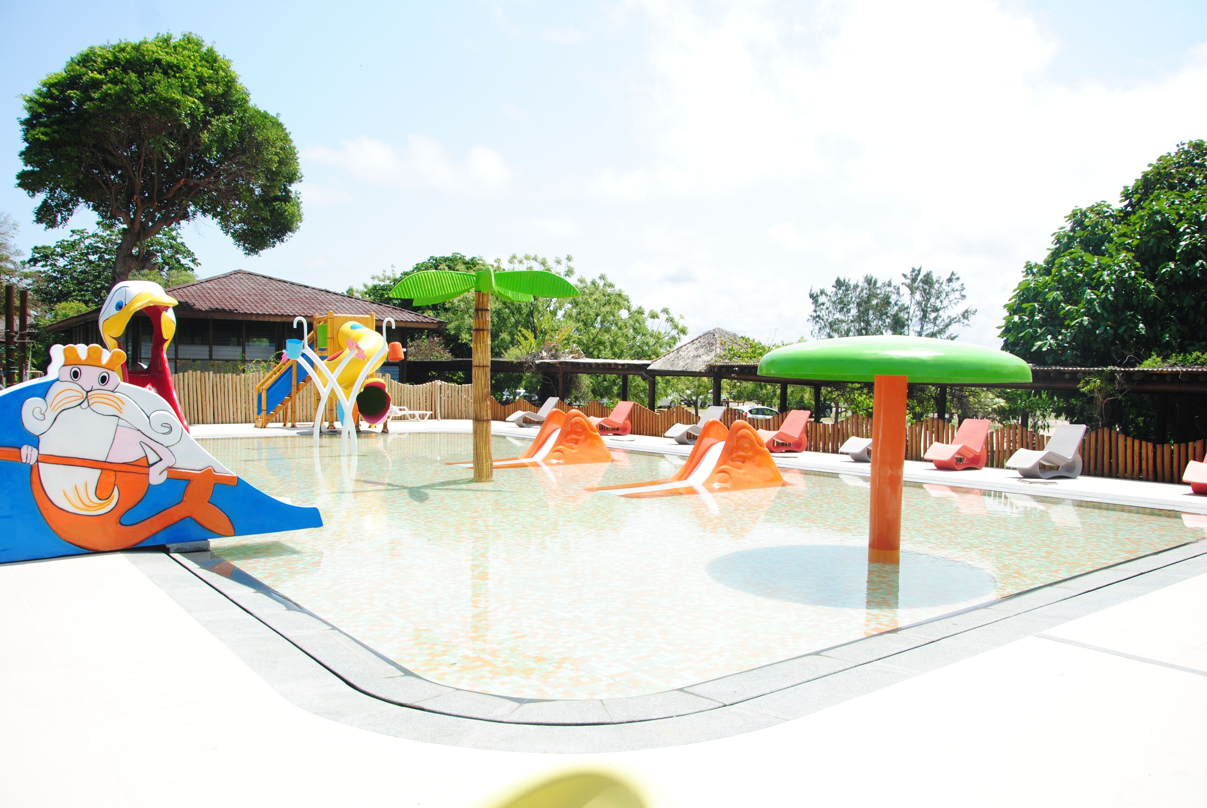 A children's play area with slides and a pool.