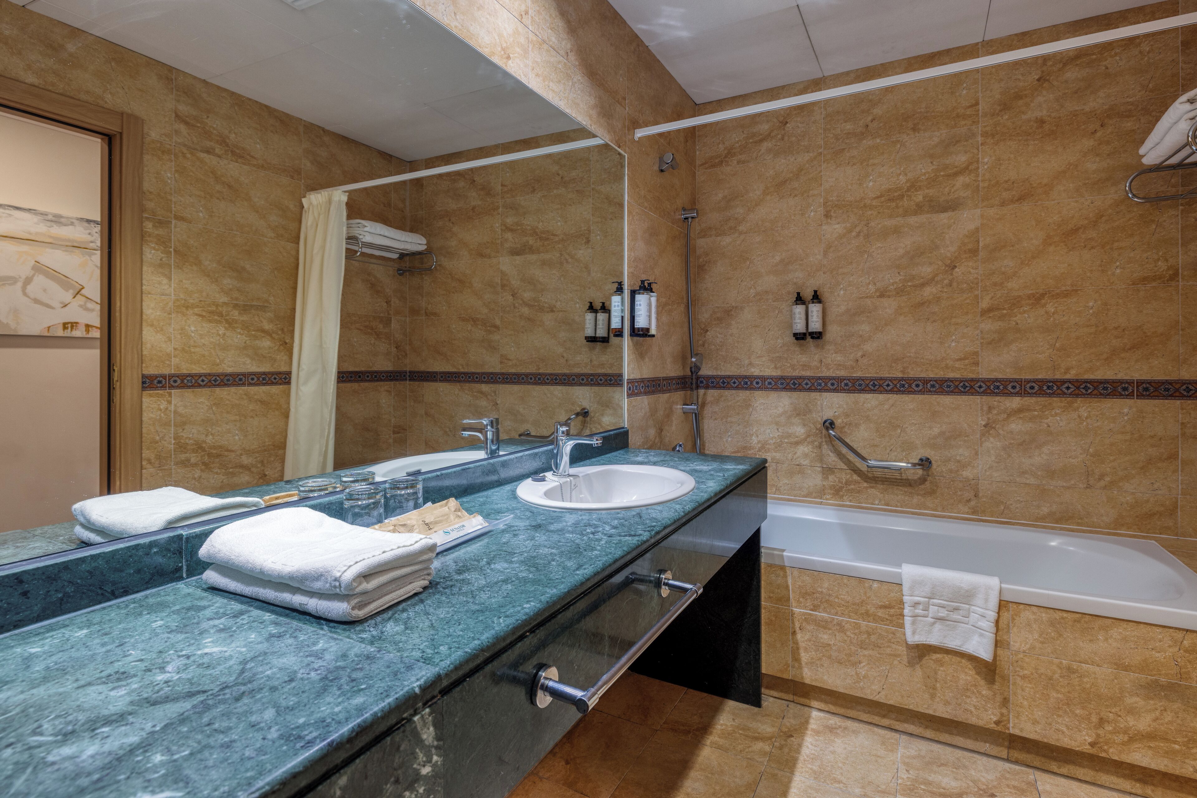 A bathroom with two sinks, a bathtub, and a shower.