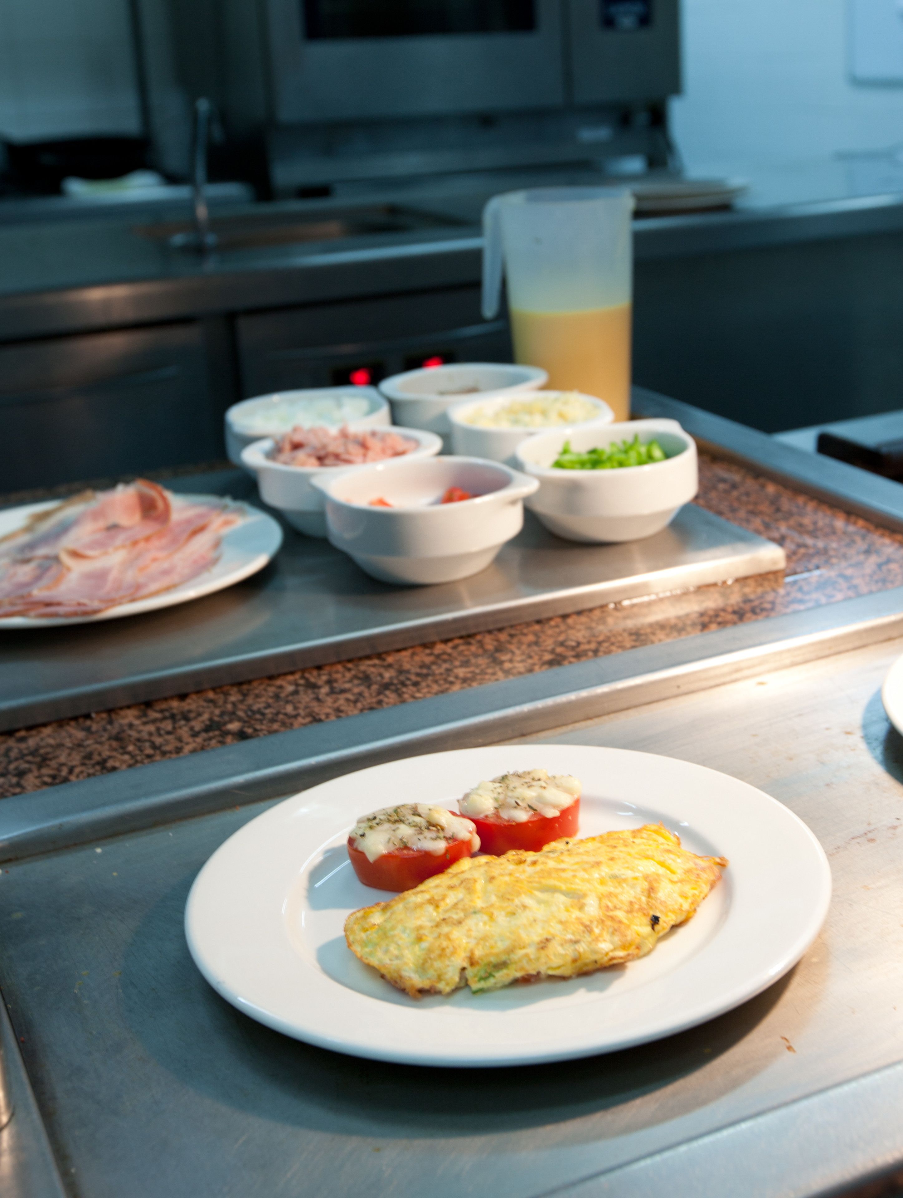 A kitchen counter with various food items and a beverage.