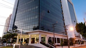 A modern building with a glass facade and a prominent entrance. - Hotel Praia Centro (Fortaleza)