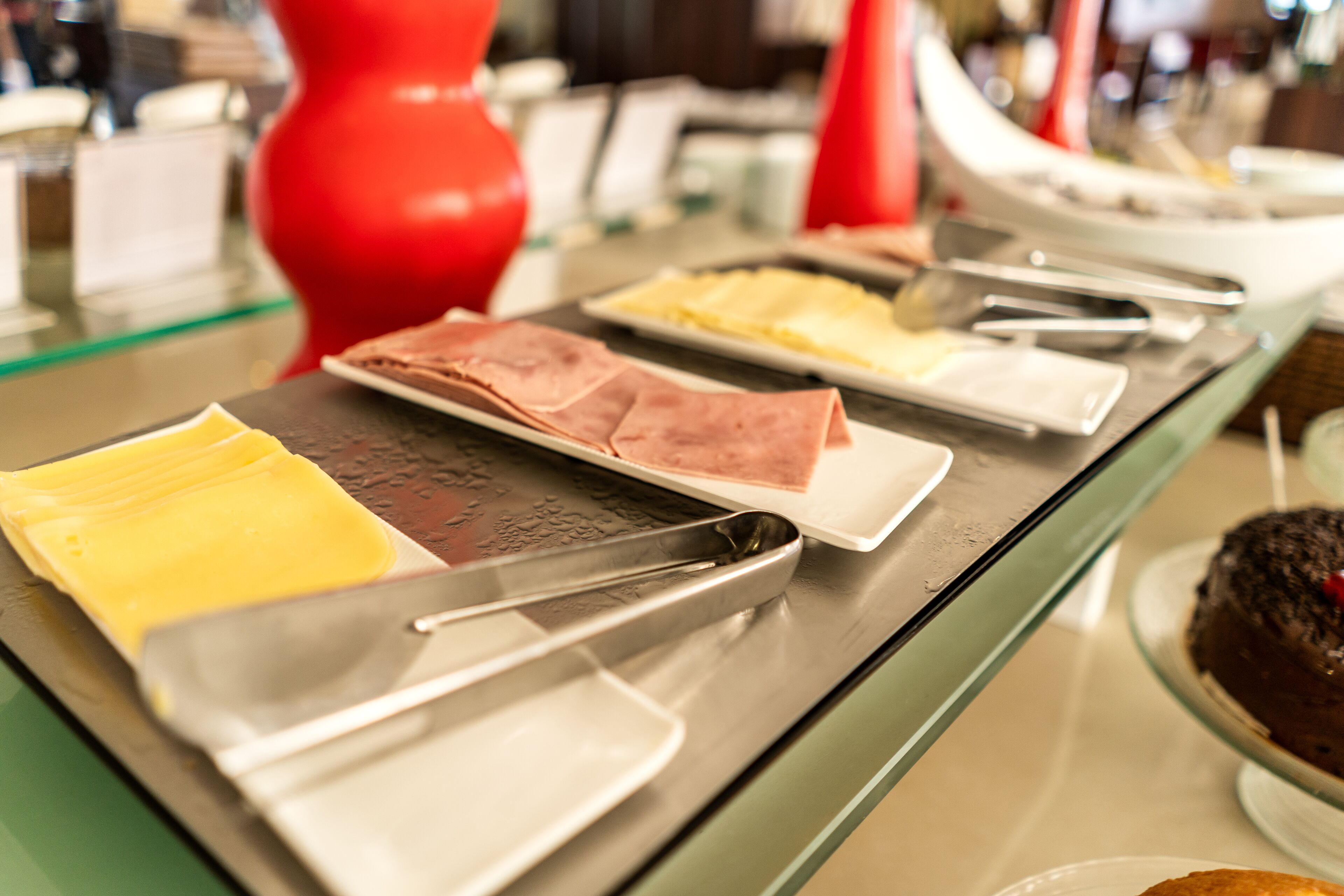 A buffet setup with various food items and serving utensils.