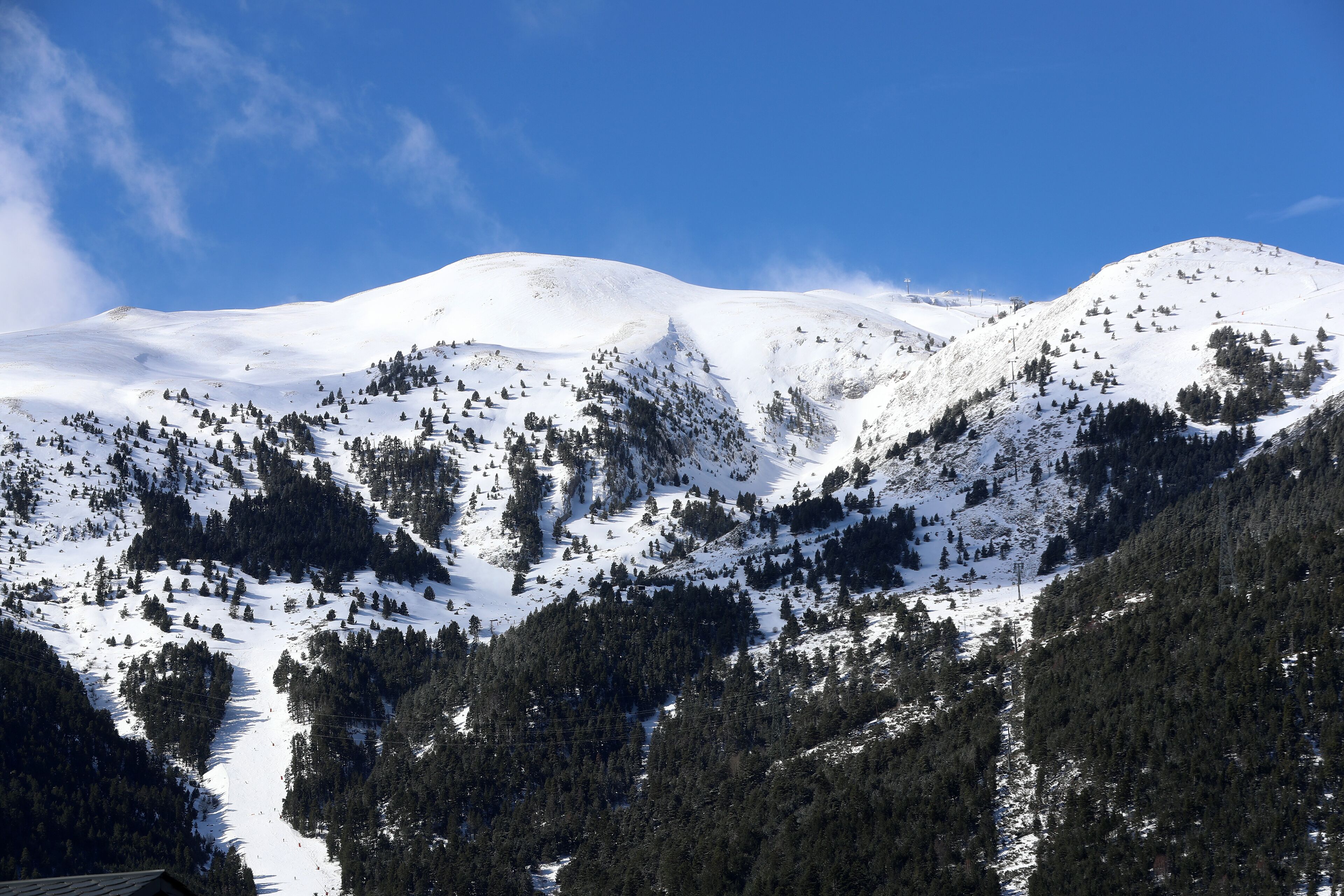 A snow-covered mountain landscape with a clear sky.
