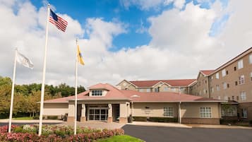 Stunning garden views surround this classic hotel, featuring a red-tiled roof and beautifully maintained grounds.