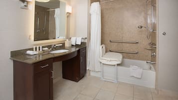 A modern bathroom with a double sink vanity, a walk-in shower, and a bathtub.