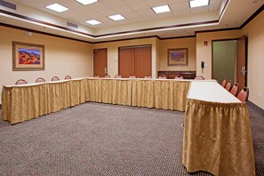 A conference room with a long table, chairs, and a carpeted floor. - Holiday Inn Express & Suites Tooele by IHG (Tooele)