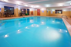 An indoor swimming pool with clear water, a shallow water sign, and a table with chairs on the side. - Holiday Inn Express & Suites Tooele by IHG (Tooele)
