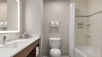 A modern bathroom with a toilet, sink, and shower.