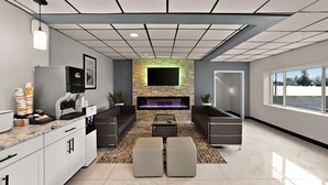 A modern living room with a fireplace, seating area, and kitchen counter with coffee machines.