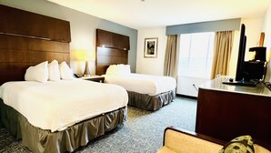 A hotel room with two beds, a desk, a chair, and a television. - Quality Inn & Suites Caribou (Caribou)