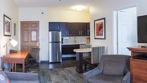 A compact living space with a kitchenette, a dining area, and seating. - Staybridge Suites Fargo by IHG (Fargo)
