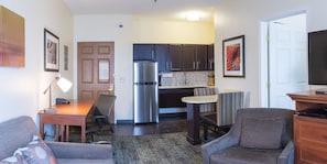 A compact living space with a kitchenette, a dining area, and seating. - Staybridge Suites Fargo by IHG (Fargo)