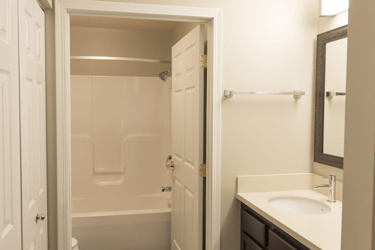 A bathroom with a bathtub, toilet, and sink.