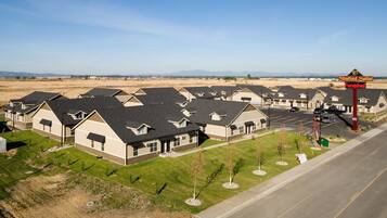 A row of modern, single-story houses with a parking lot in front, labeled as "Stratford Suites Furnished."