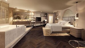 Una habitación de hotel moderna con una cama grande, un baño independiente con bañera, un escritorio con ordenador y un espejo amplio.
