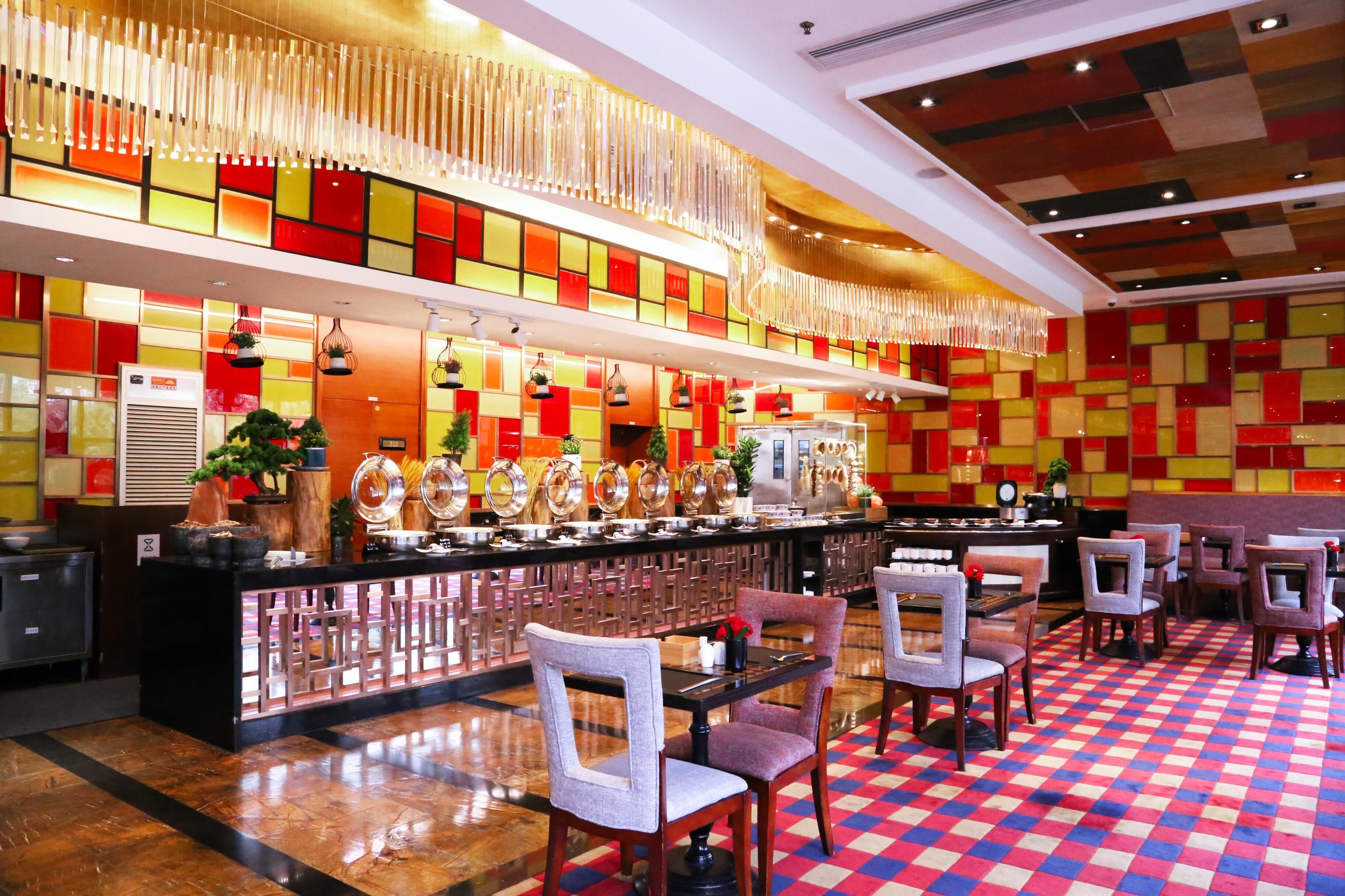 A restaurant with a checkered floor, a bar area, and a seating arrangement.