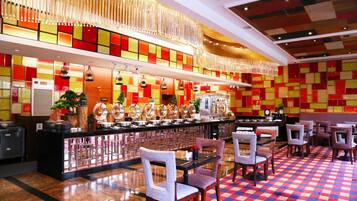 A restaurant with a checkered floor, a bar area, and a seating arrangement.