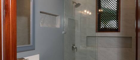 A bathroom with a sink, mirror, and toilet.