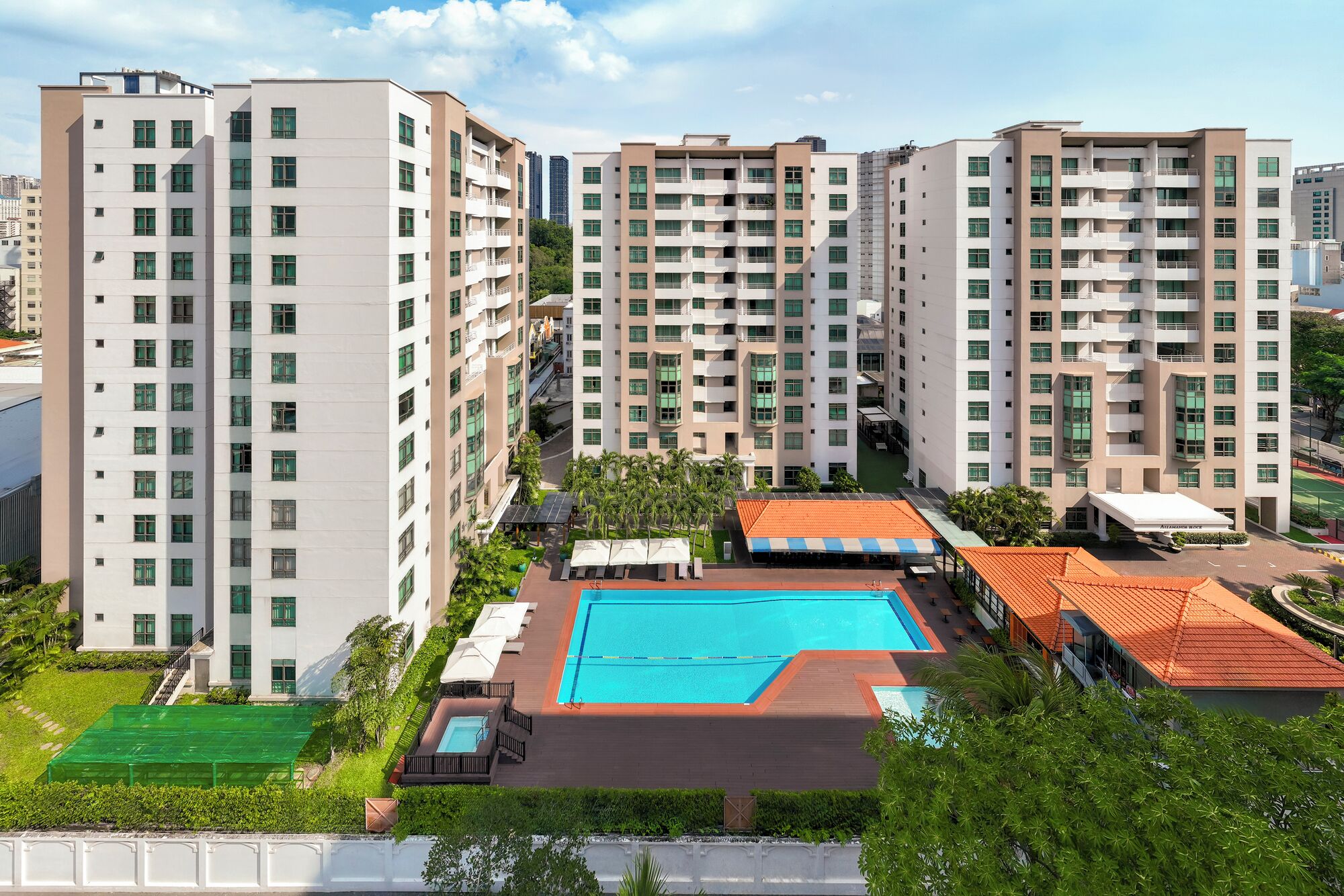 A high-rise residential building with multiple balconies, a swimming pool, and a rooftop garden.