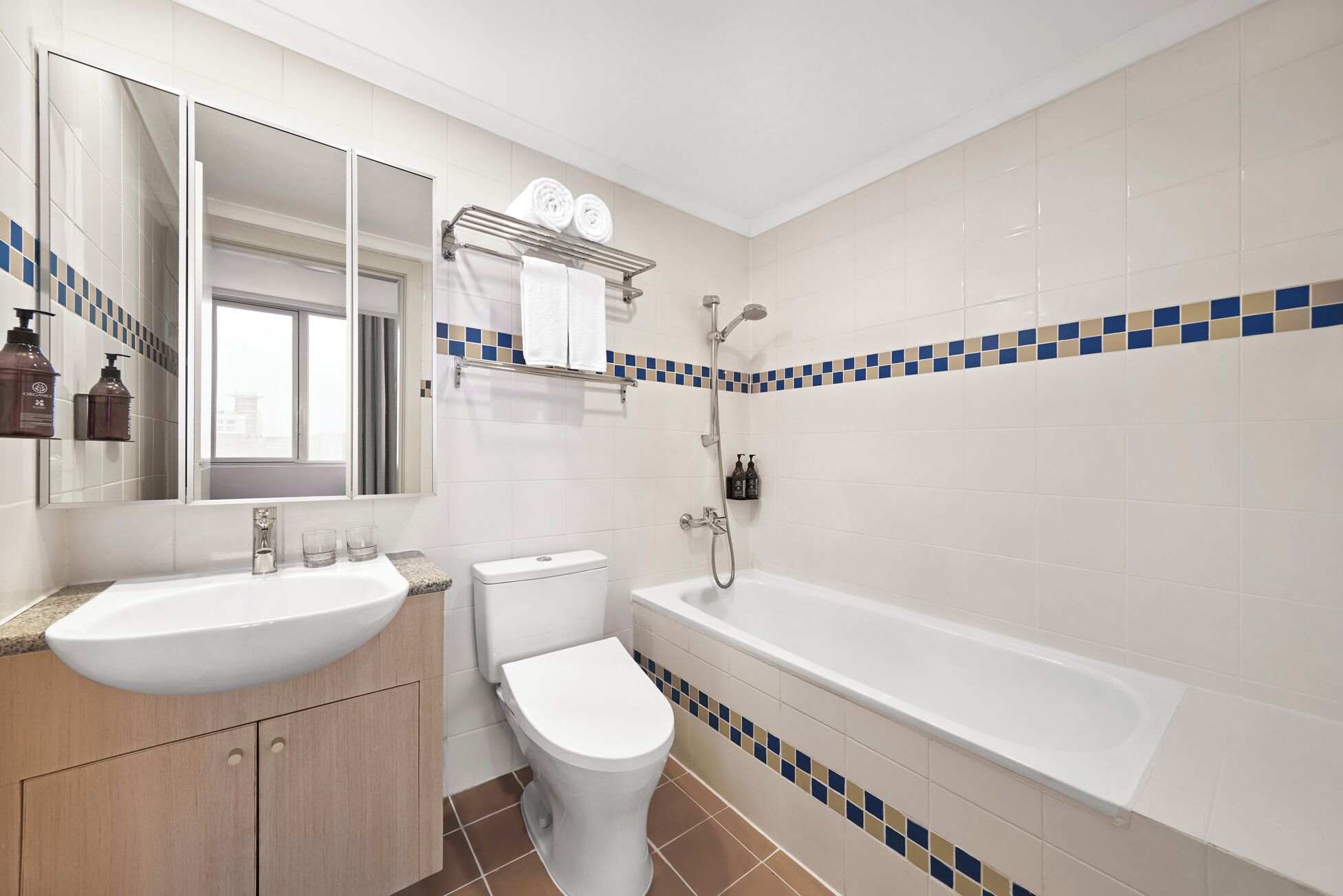 A bathroom with a sink, toilet, and bathtub.